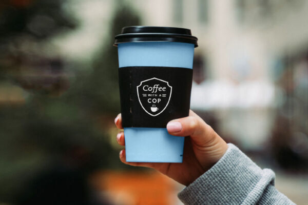 Hand holding coffee cup.