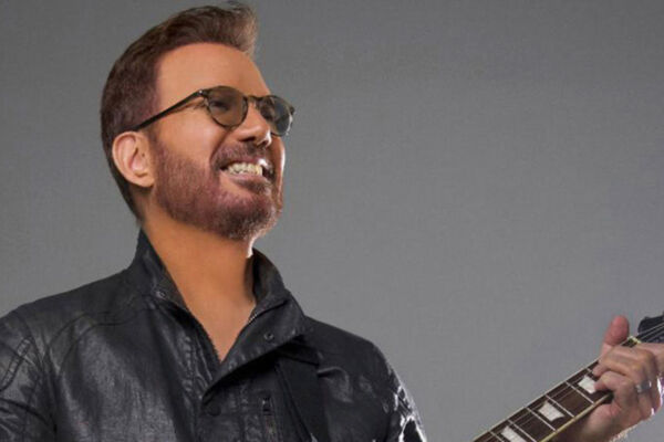 Picture of singer Willy Chirino holding a guitar