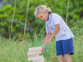 BH 4th of July 2023 110 Child playing Jenga on the beach.