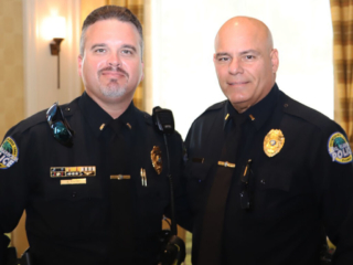 BHV 6-15-23 2 Police officers taking a picture.