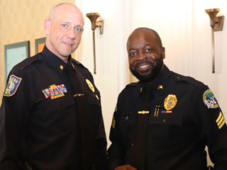 BHV 6-15-23 9 Police officers taking a picture.