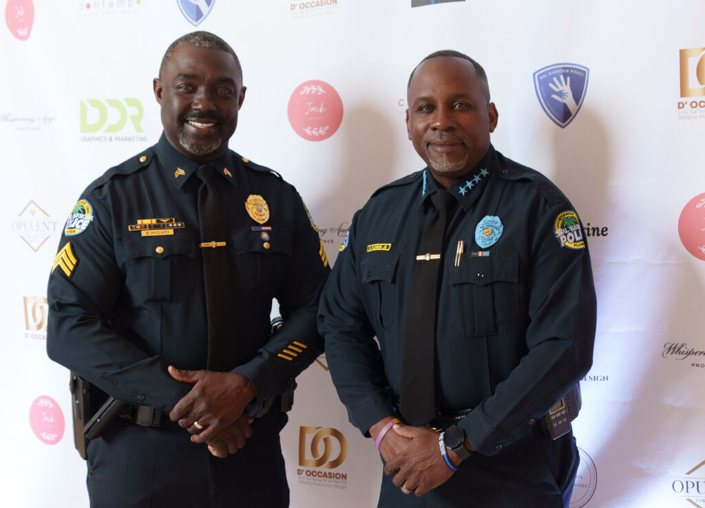 The Chief of Police and a sergeant taking a picture