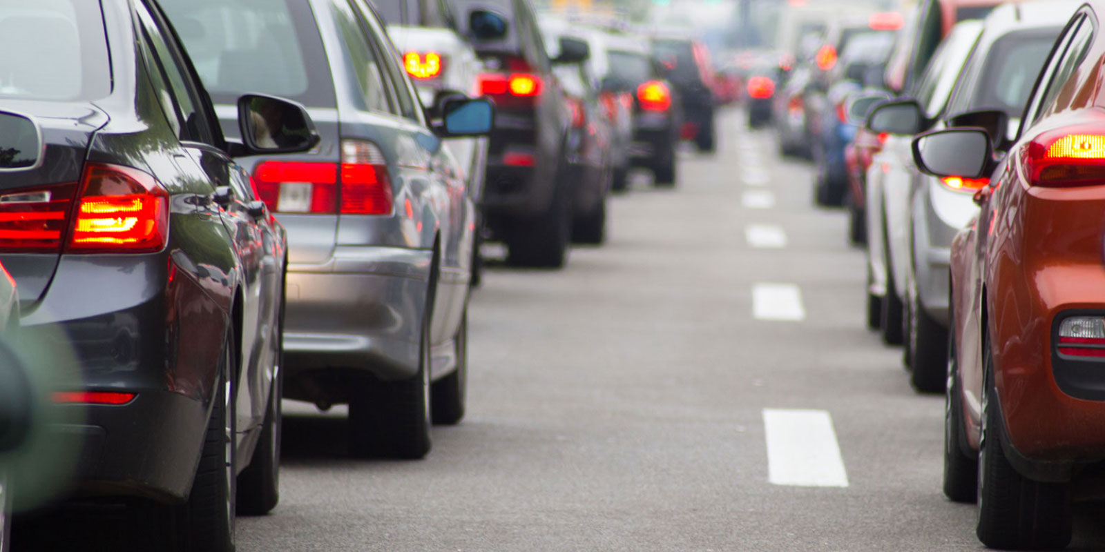 Vehicles on road, in traffic with text Traffic Alert.